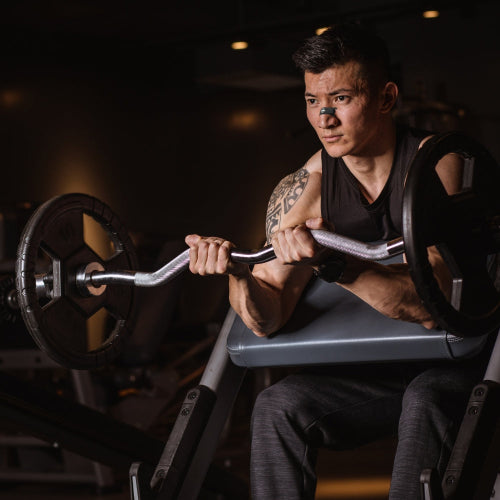 Man lifting a barbell in a gym setting